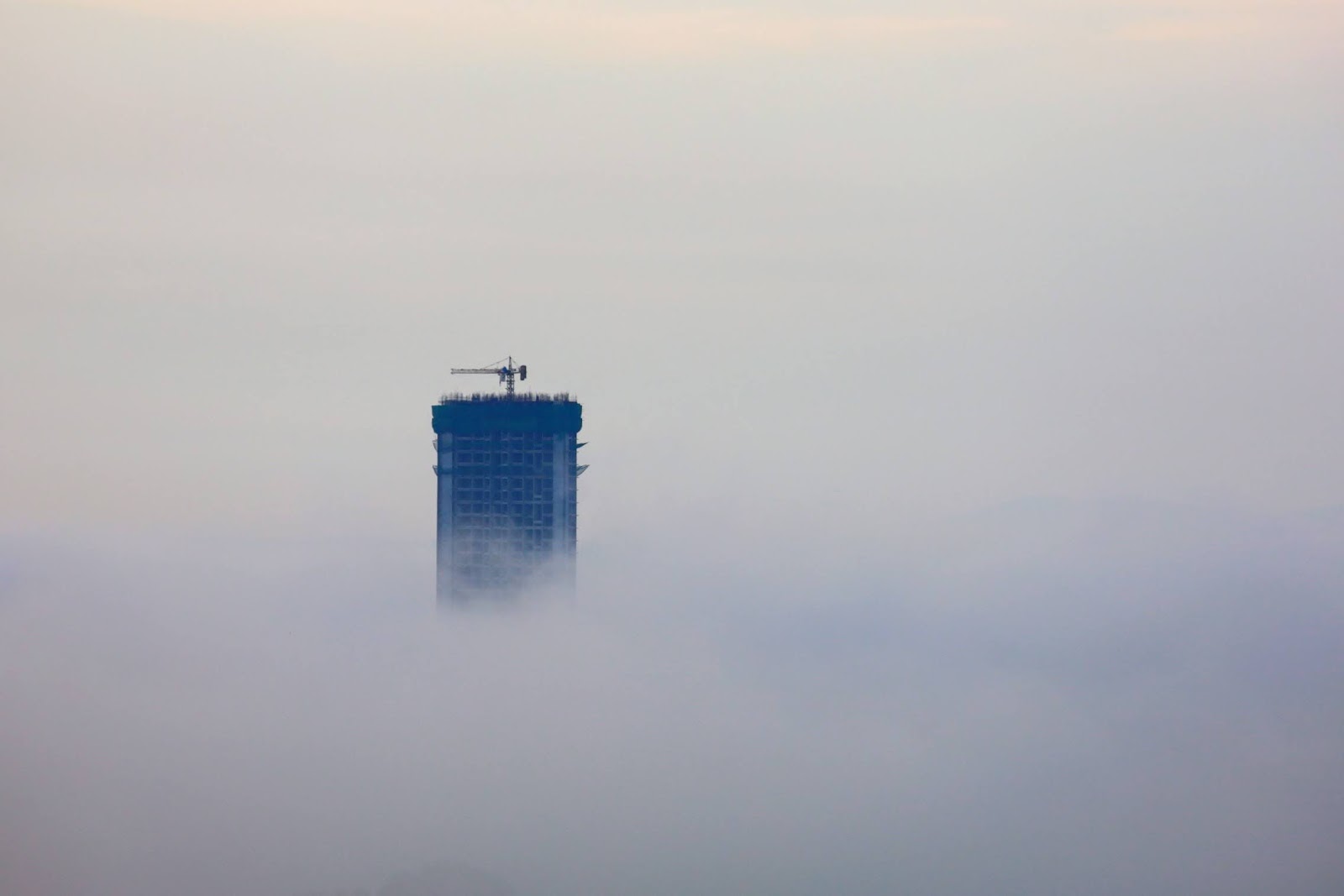 The tower rising above morning cloud